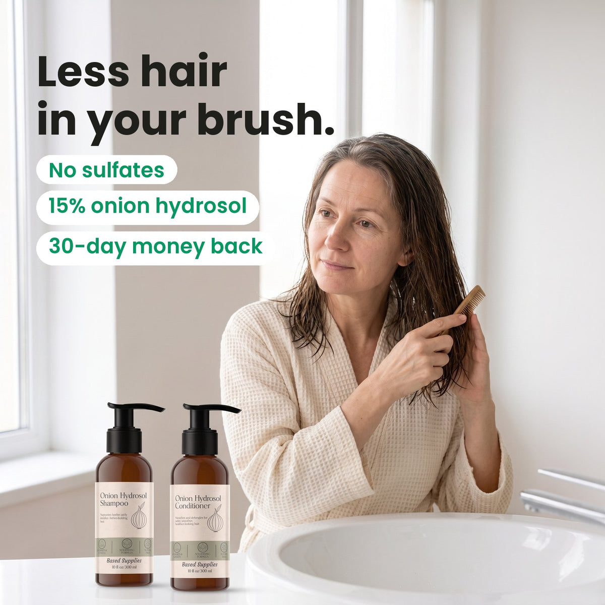 A woman combing her damp hair at the bathroom sink, with the Onion Hydrosol Shampoo and Conditioner